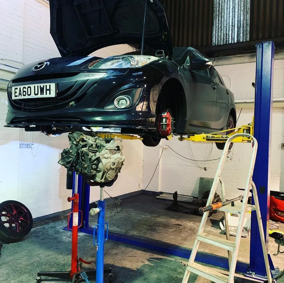 Car raised on a ramp for repairs at CJ Performance Mansfield