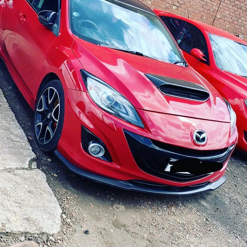 Red Mazda hatchback after repairs at CJ Performance Mansfield